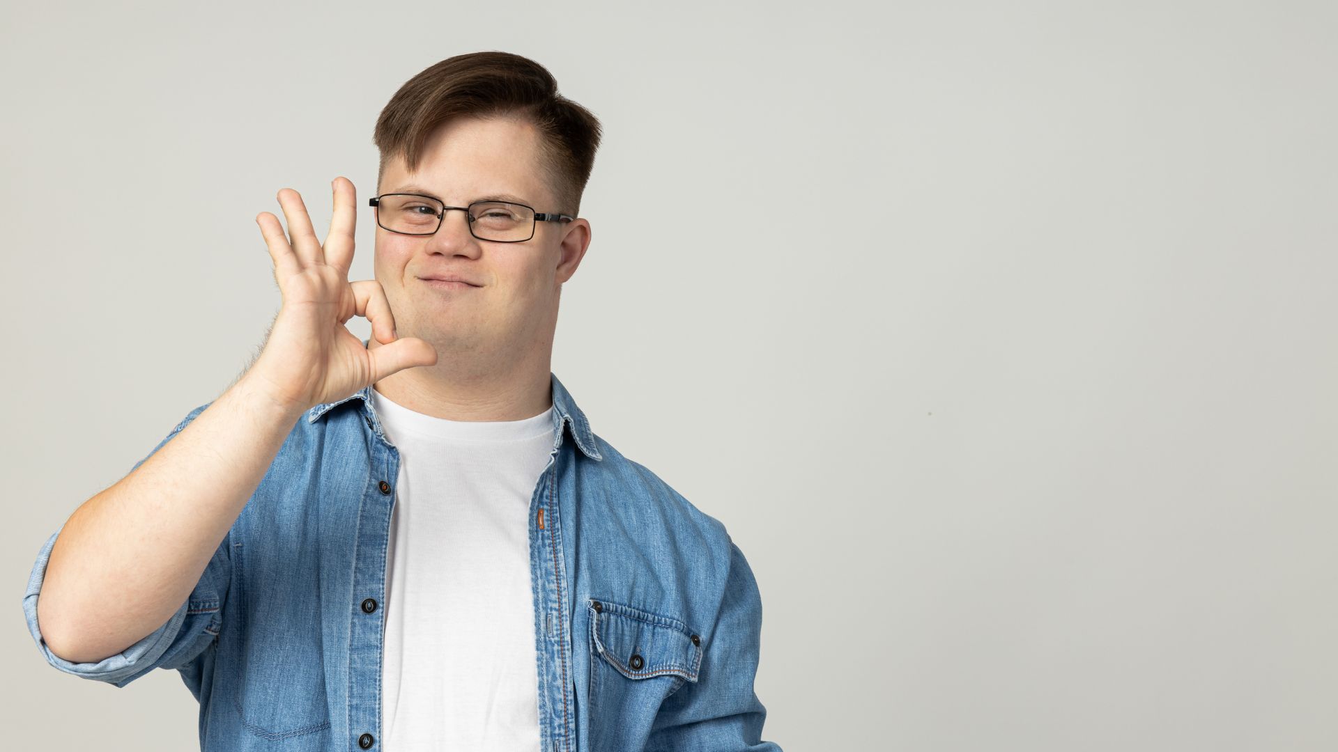 Two Helpers Picking up Disabled Senior Woman for Transport