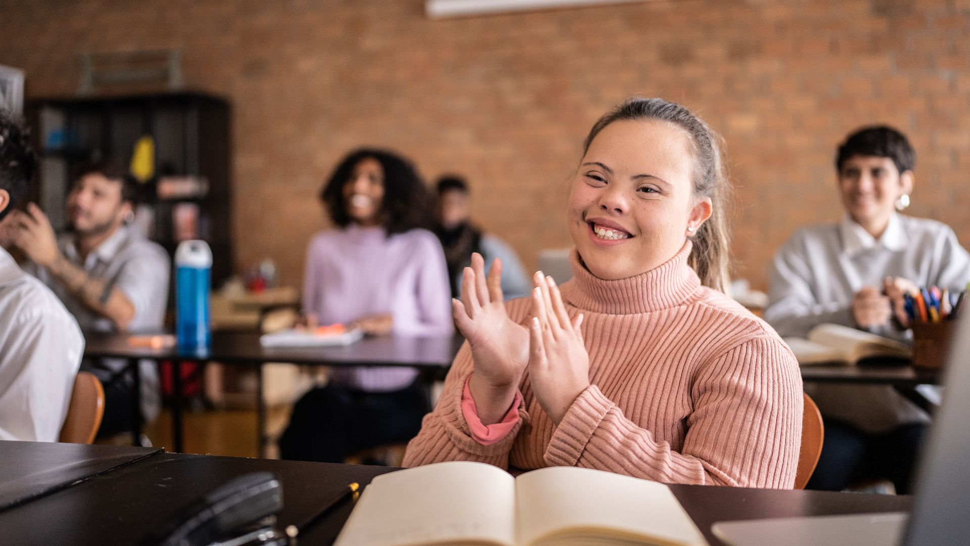 Disabled Student Clapping Her Hands Woman Sitting on Wheelchair While Using Laptop