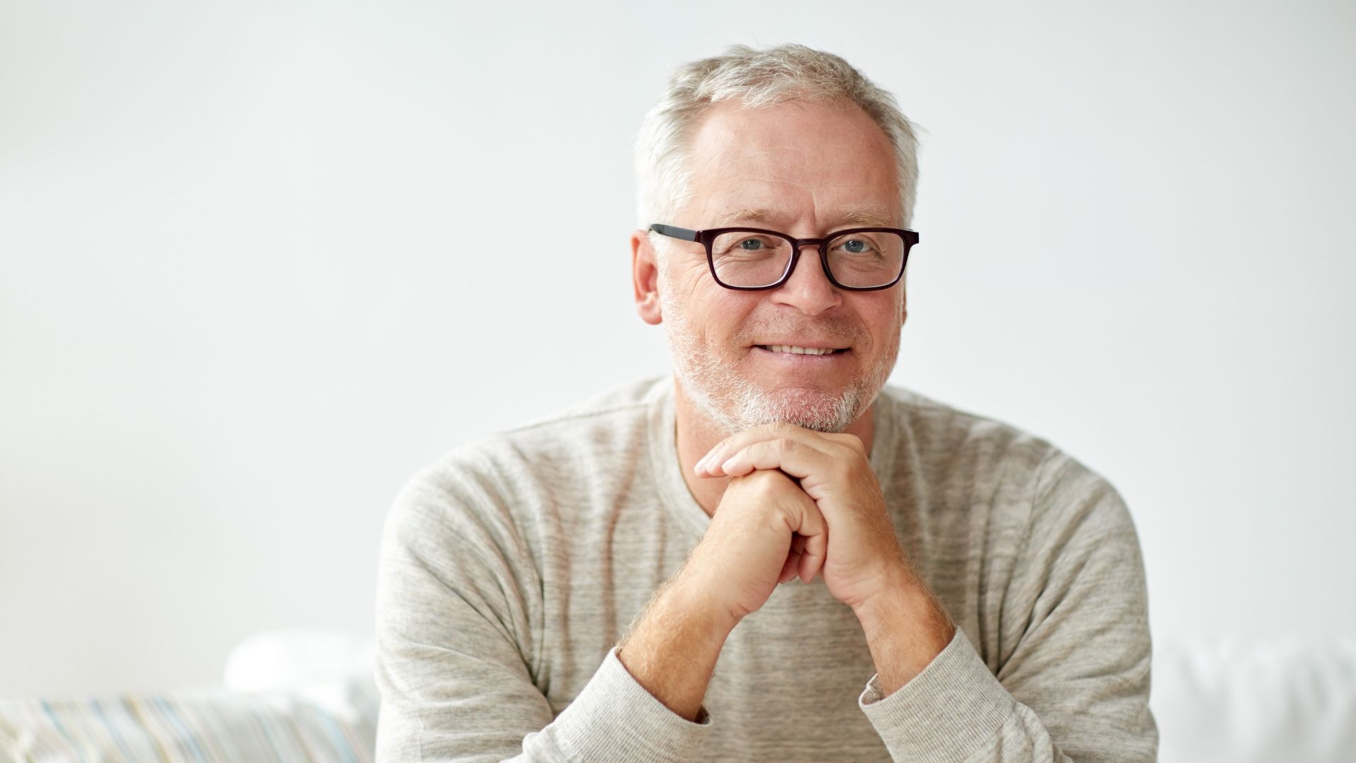 Smiling Senior Man Two Helpers Picking up Disabled Senior Woman for Transport